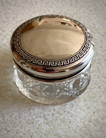 A cut glass vanity jar with silver lid, hallmarked 1922 by S. Blanckensee & Son Ltd.