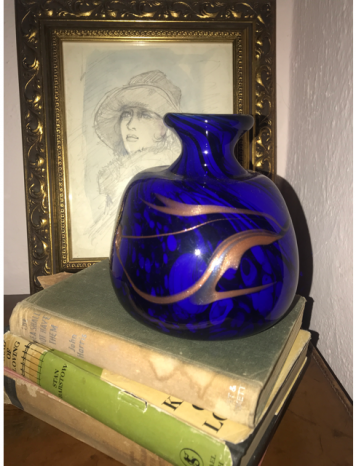 A stunning studio glass vase with cobalt blue and bronze coloured swirl decoration