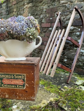 A Vintage Wooden Sleigh with Metal Edged Runners and Bar