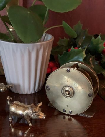 A Vintage Miniature Fishing Reel With Fixed Wooden Handle