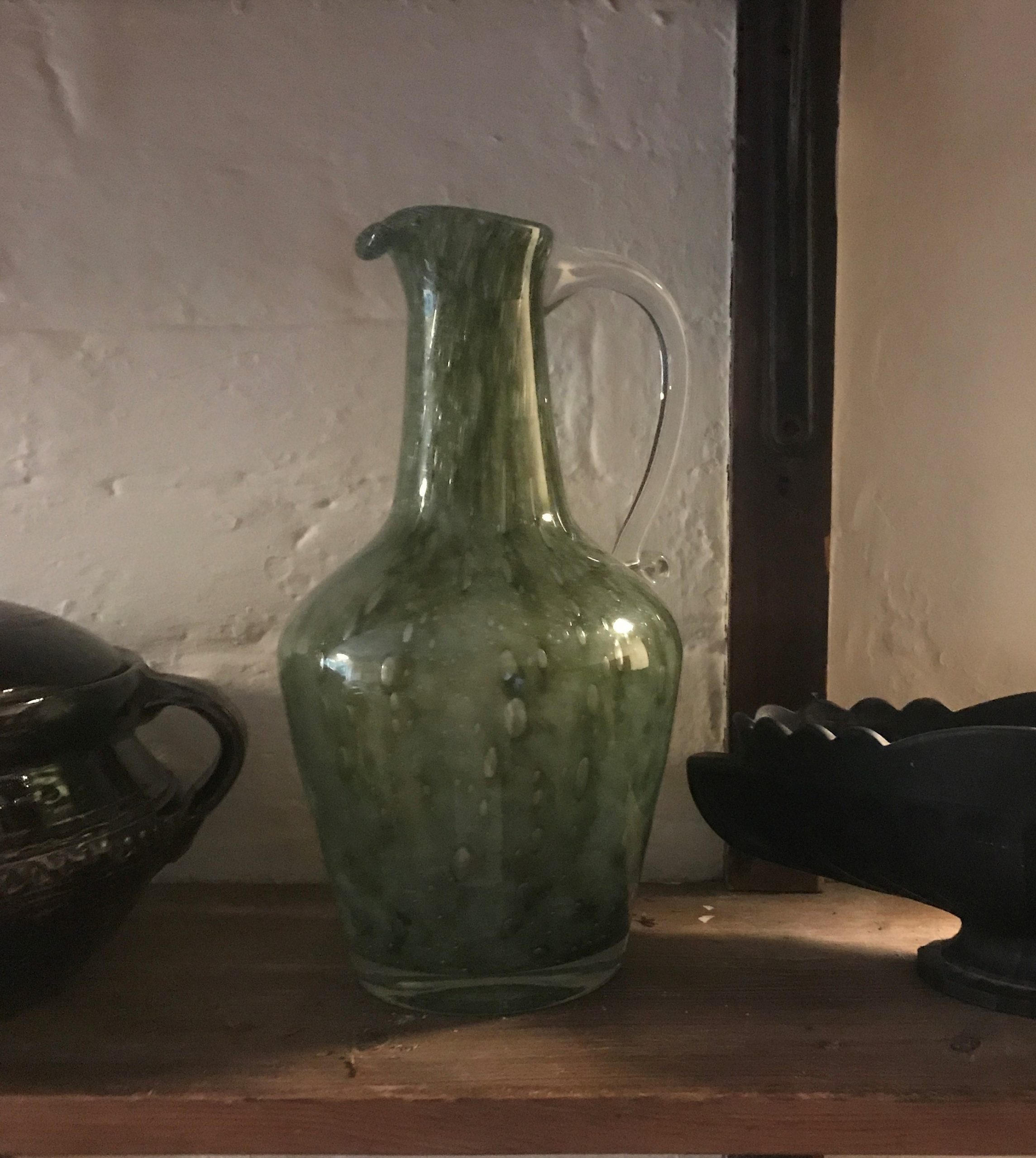 An Unusual Handblown Green Glass Jug with Clear Scroll Handle
